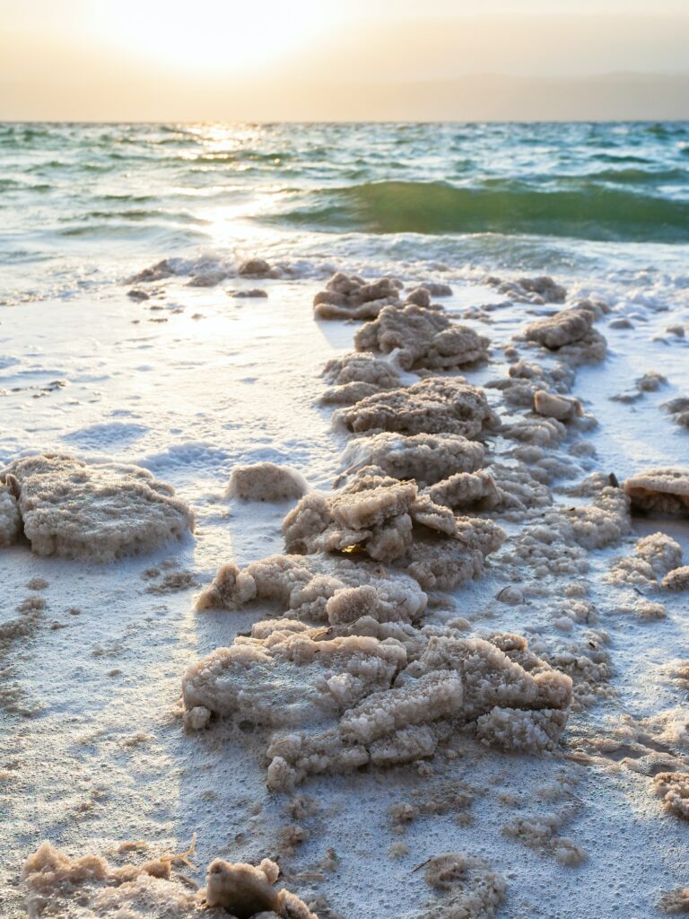 crystalline salt on coast of Dead Sea on sunset